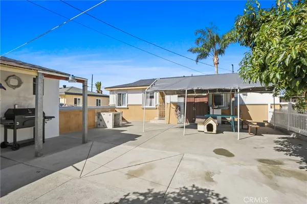 a view of a house with backyard porch and sitting area