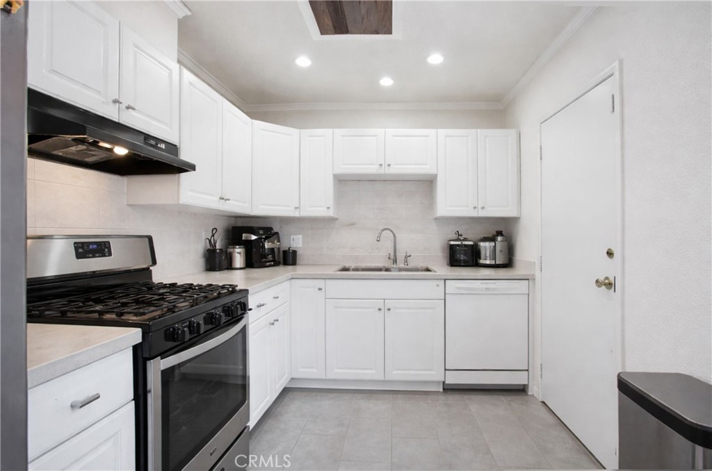 618 East 225th Street Carson, CA 90745 - Photo 7 of 14 a kitchen with cabinets stainless steel appliances and a counter space