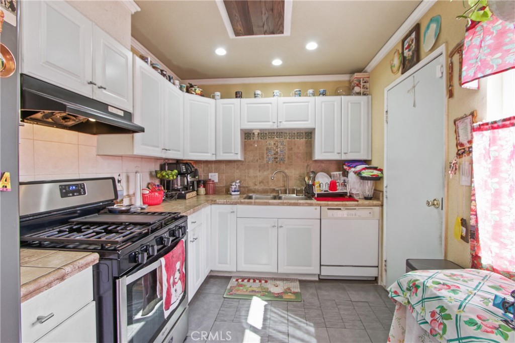 618 East 225th Street Carson, CA 90745 - Photo 8 of 14 a kitchen with stainless steel appliances granite countertop a stove a sink and a refrigerator