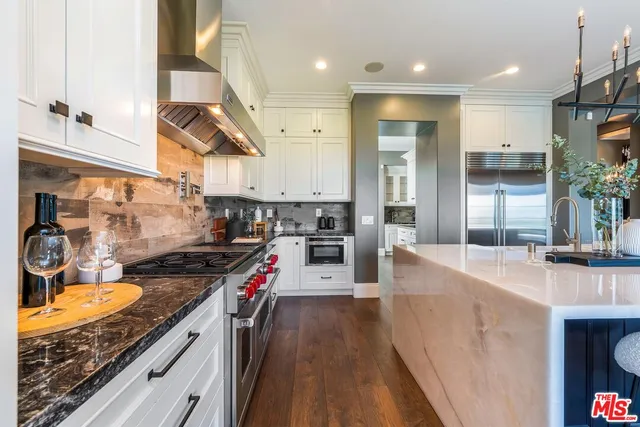 a large kitchen with a table and chairs