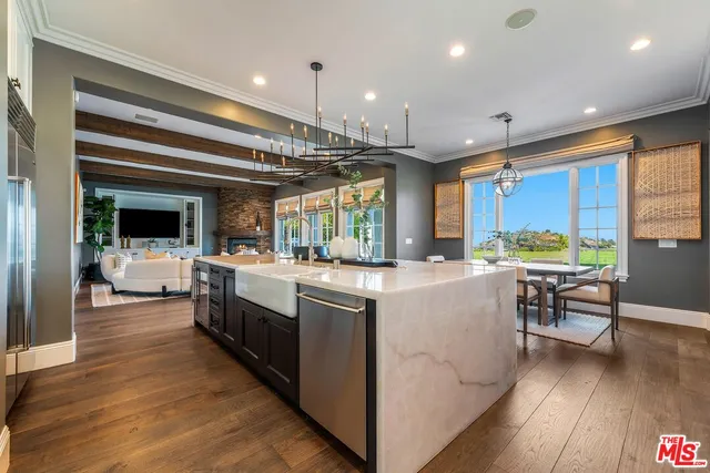 a view of a dining room with furniture wooden floor and chandelier