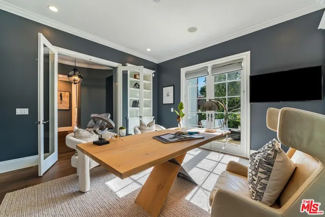 a spacious bedroom with a bed and a chandelier