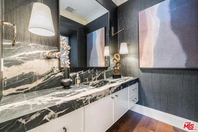 a bathroom with a granite countertop sink toilet a mirror a vanity and shower