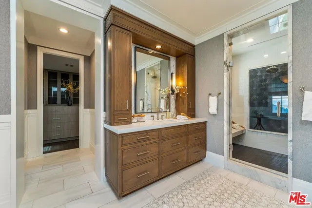 a bathroom with a double vanity sink and a mirror