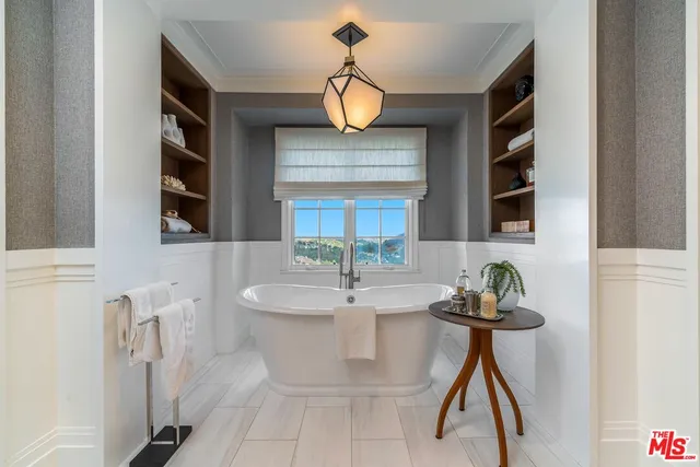 a living room with furniture a rug and a large window