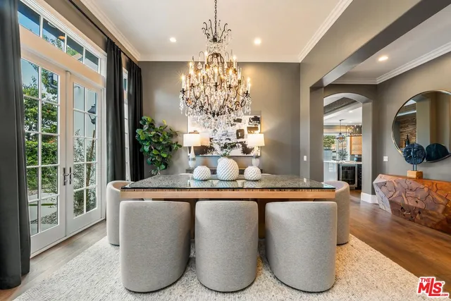a dining room with granite countertop wooden floor and large windows