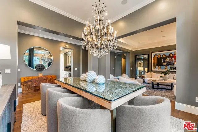 a dining room with granite countertop a couch and chandelier