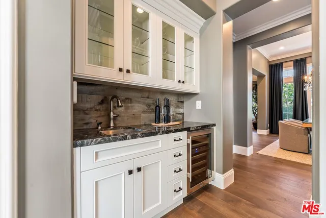 a kitchen with stainless steel appliances kitchen island granite countertop a stove a sink a refrigerator and island