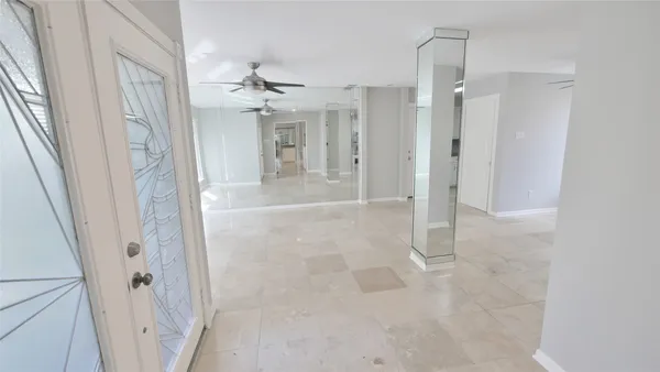 a view of a hallway with entryway and kitchen view