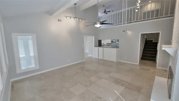 a kitchen with kitchen island sink and cabinets