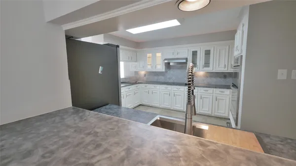 a kitchen with stainless steel appliances granite countertop a sink and cabinets