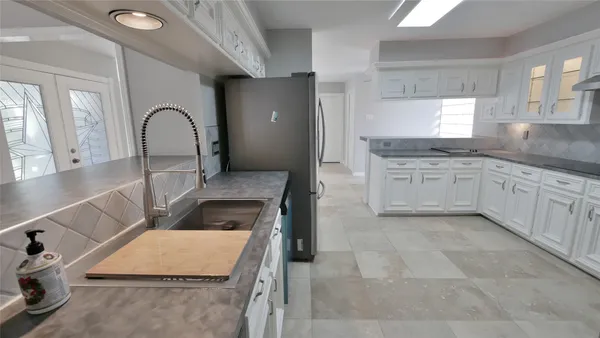 a kitchen with stainless steel appliances granite countertop a refrigerator sink and cabinets