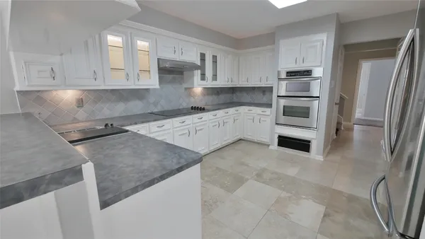 a kitchen with a refrigerator and a sink