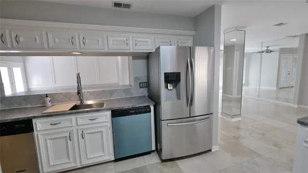 a view of a livingroom with a kitchen