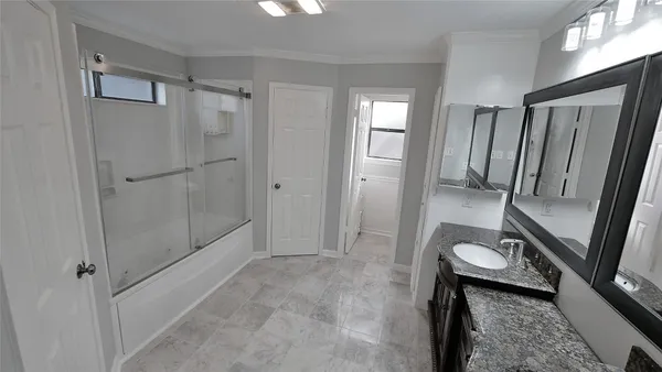 a bathroom with a glass shower door