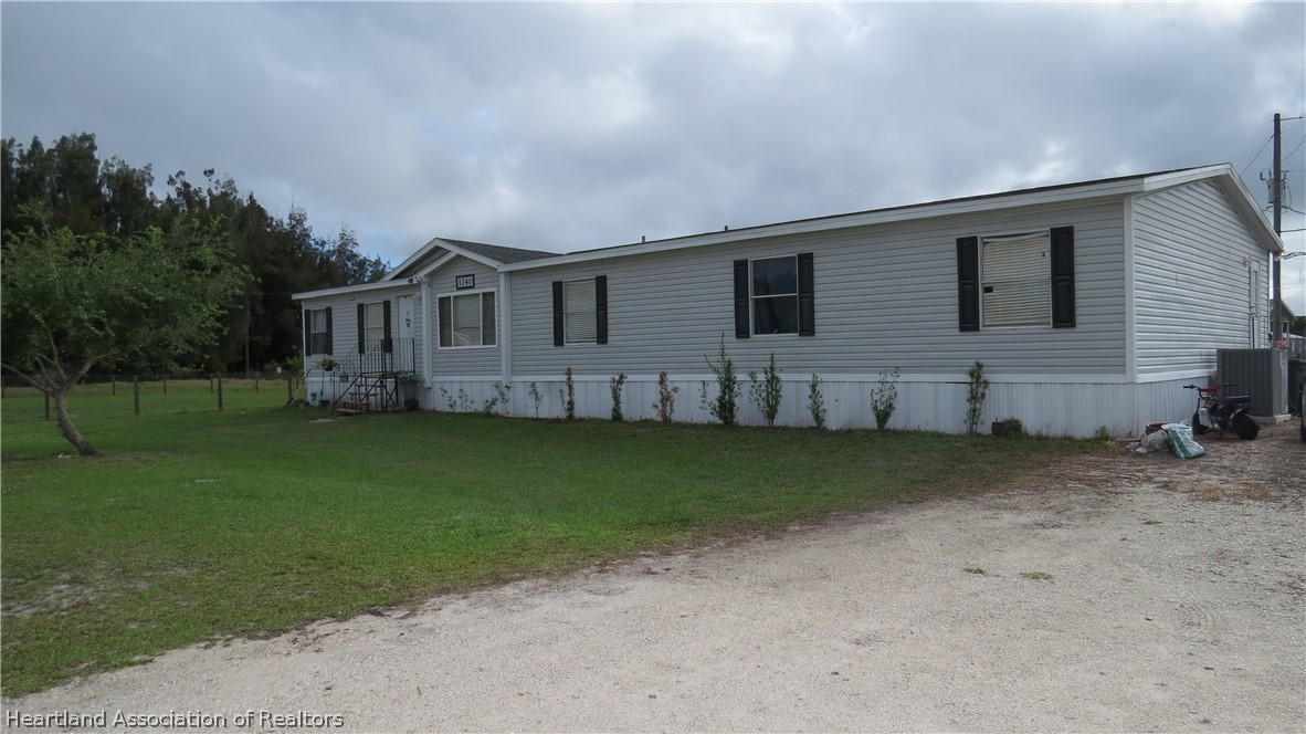 1346 Cardinal Road Wauchula, FL 33873 - Photo 1 of 2 a view of a house with a backyard