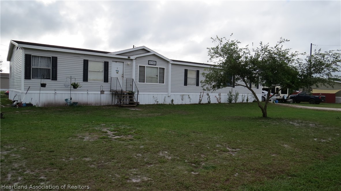 1346 Cardinal Road Wauchula, FL 33873 - Photo 2 of 2 a view of house with a yard