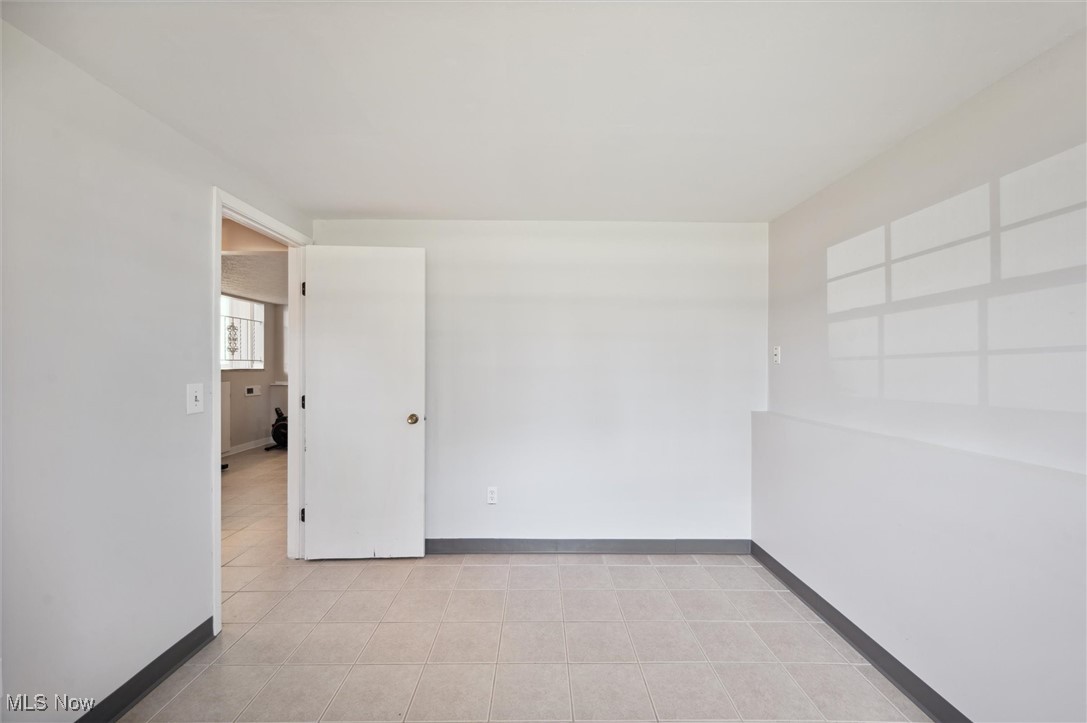 5476 Lear Nagle Road North Ridgeville, OH 44039 - Photo 28 of 38 Spare room with light tile patterned floors and baseboards