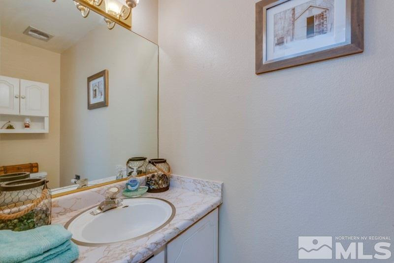 404 Smithridge Drive Reno, NV 89502 - Photo 12 of 12 a bathroom with a sink mirror and toilet