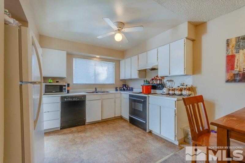 404 Smithridge Drive Reno, NV 89502 - Photo 4 of 12 a kitchen with cabinets and stainless steel appliances