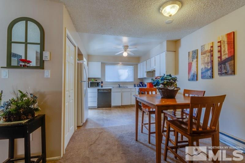 404 Smithridge Drive Reno, NV 89502 - Photo 6 of 12 a view of a dining room with furniture and a potted plant