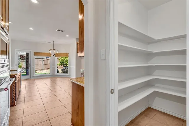 a view of a hallway with wooden shelves