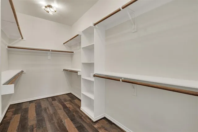 a view of walk in closet with empty racks