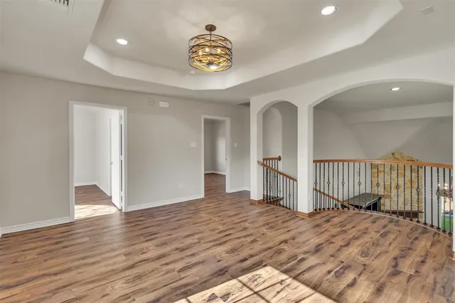 a view of a room with wooden floor