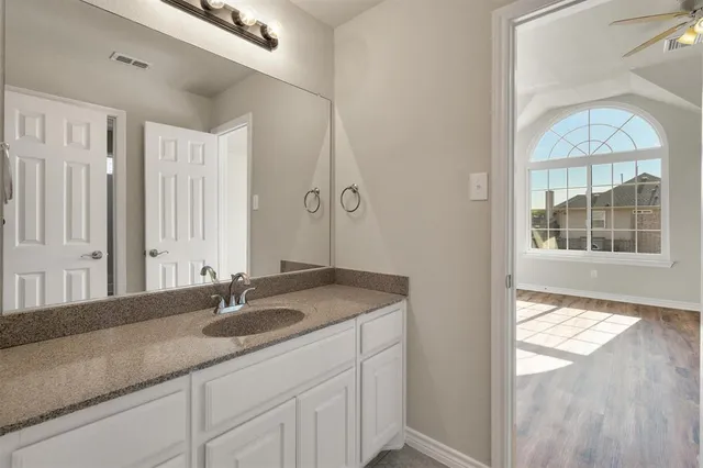 a bathroom with a sink and a window