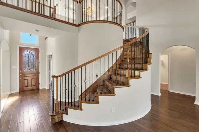 a view of entryway and hall with wooden floor