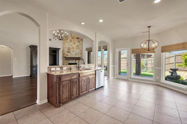 a large kitchen with granite countertop a large counter top and appliances