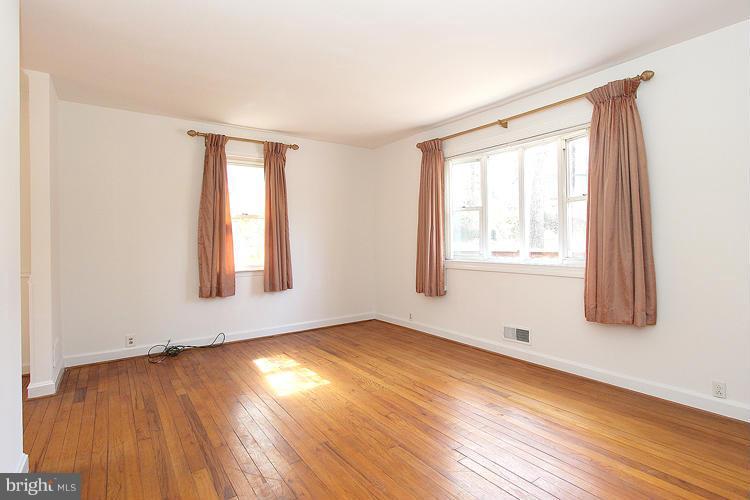 11601 Gail Place Silver Spring, MD 20902 - Photo 7 of 30 an empty room with wooden floor and windows