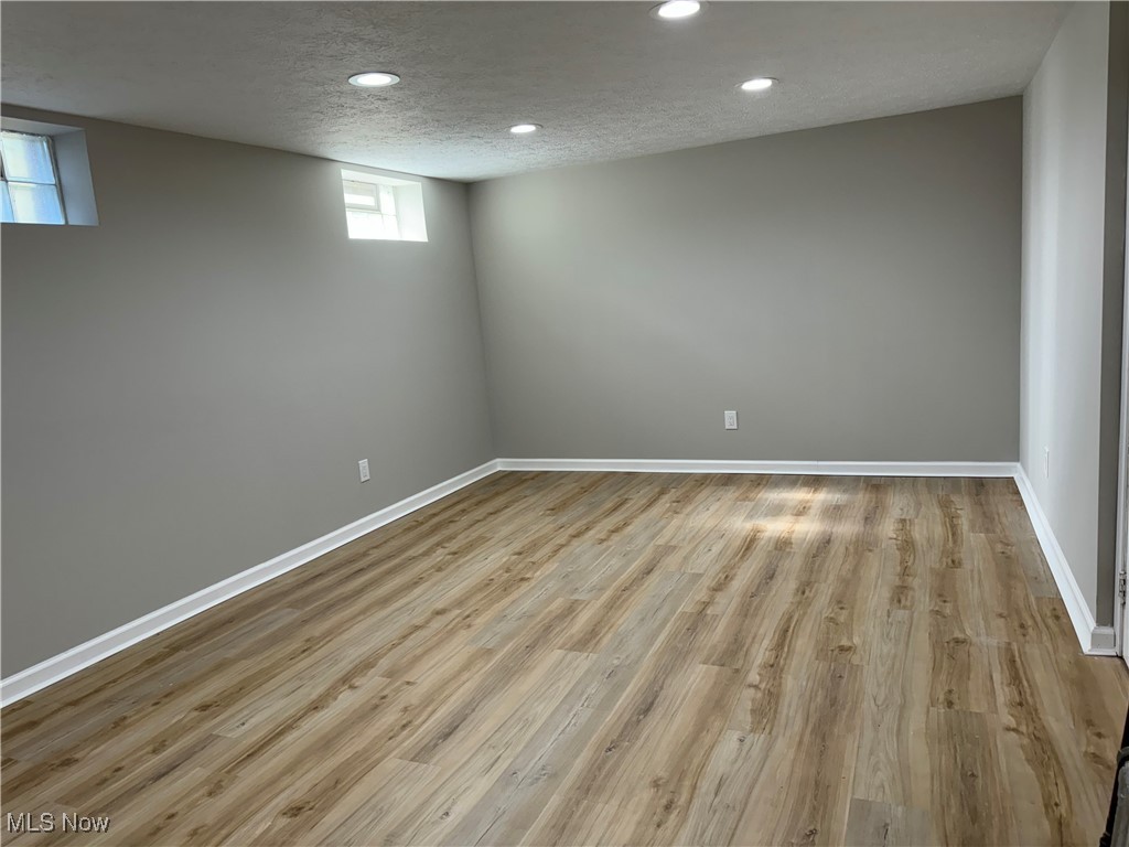 1729 East Pleasant Valley Road Independence, OH 44131 - Photo 32 of 41 Basement featuring a textured ceiling and light wood-type flooring