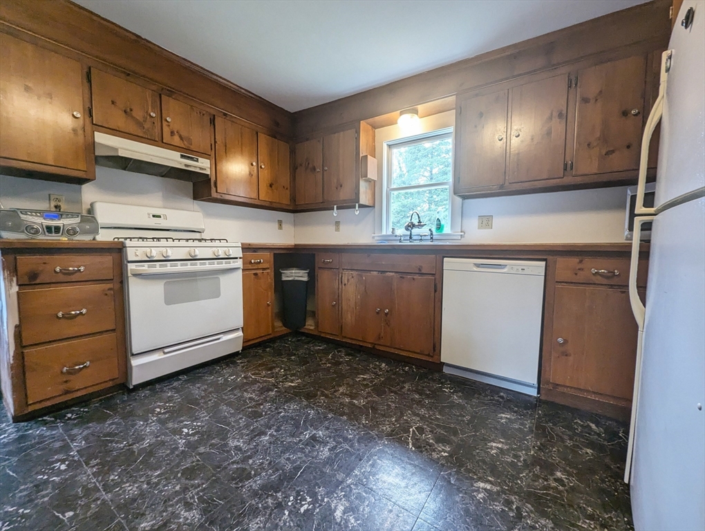 106 Great Neck Road Wareham, MA 02571 - Photo 18 of 30 a kitchen with granite countertop a sink stainless steel appliances and cabinets