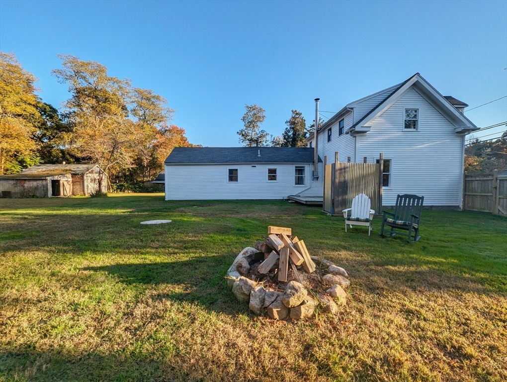106 Great Neck Road Wareham, MA 02571 - Photo 9 of 30 a backyard of a house with table and chairs