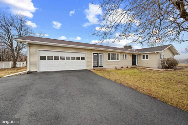 a view of an house with backyard space and balcony