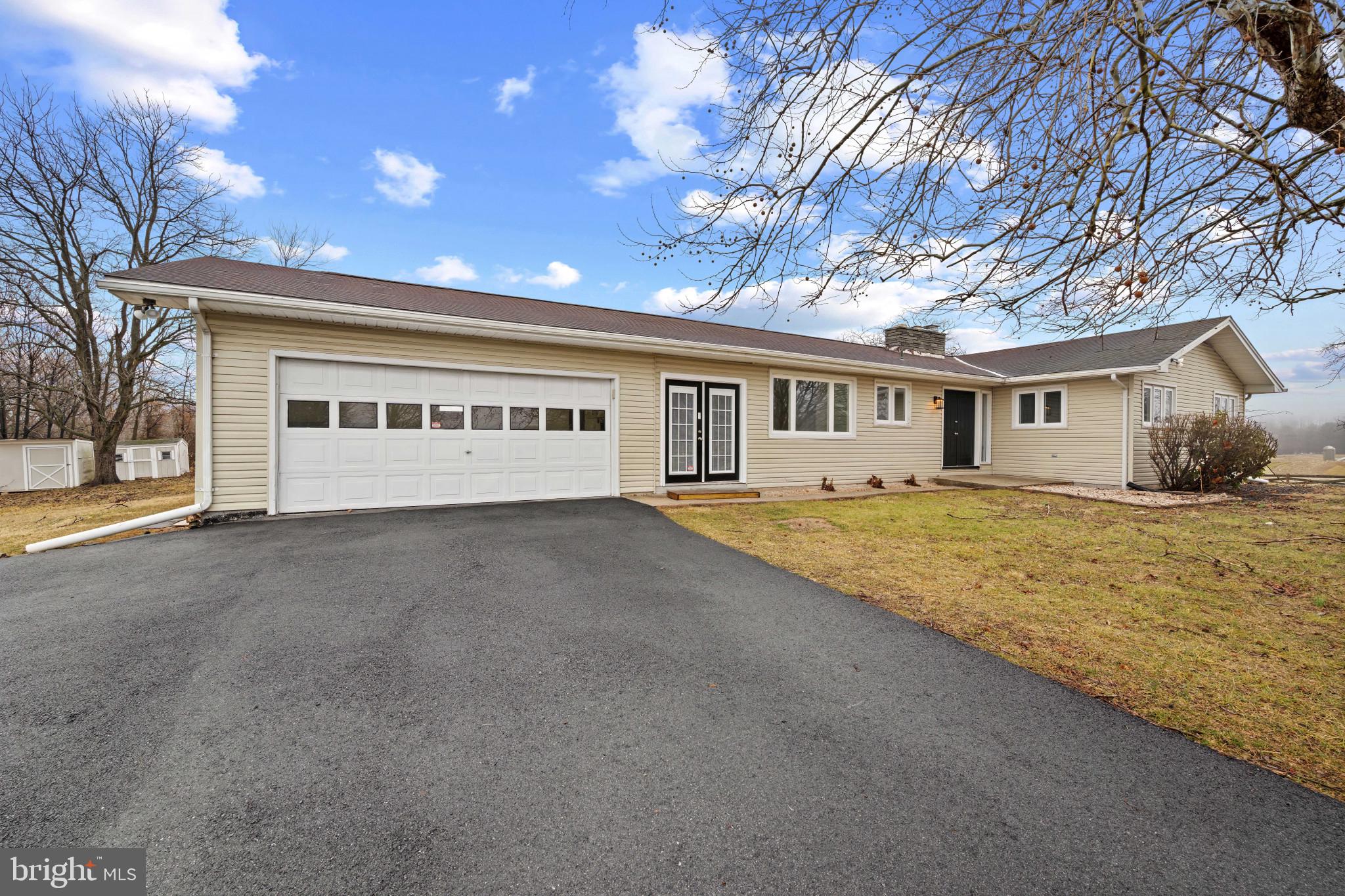 a view of an house with backyard space and balcony