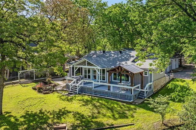 a front view of a house with swimming pool and sitting area