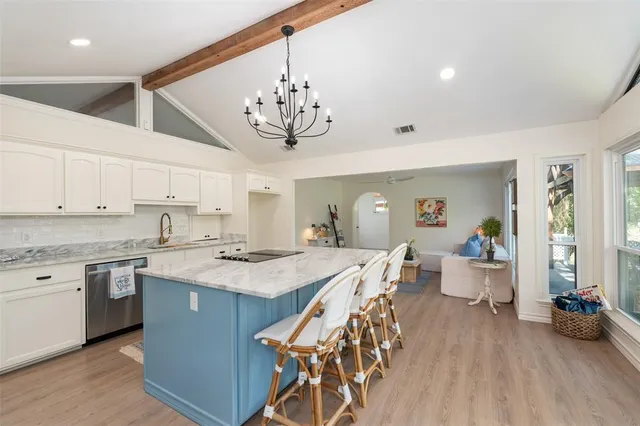 a view of a dining room with furniture wooden floor and chandelier