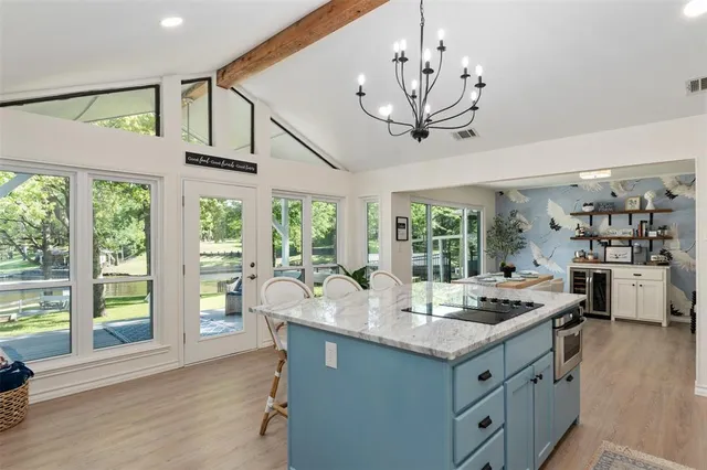 a kitchen with granite countertop a sink and a stove