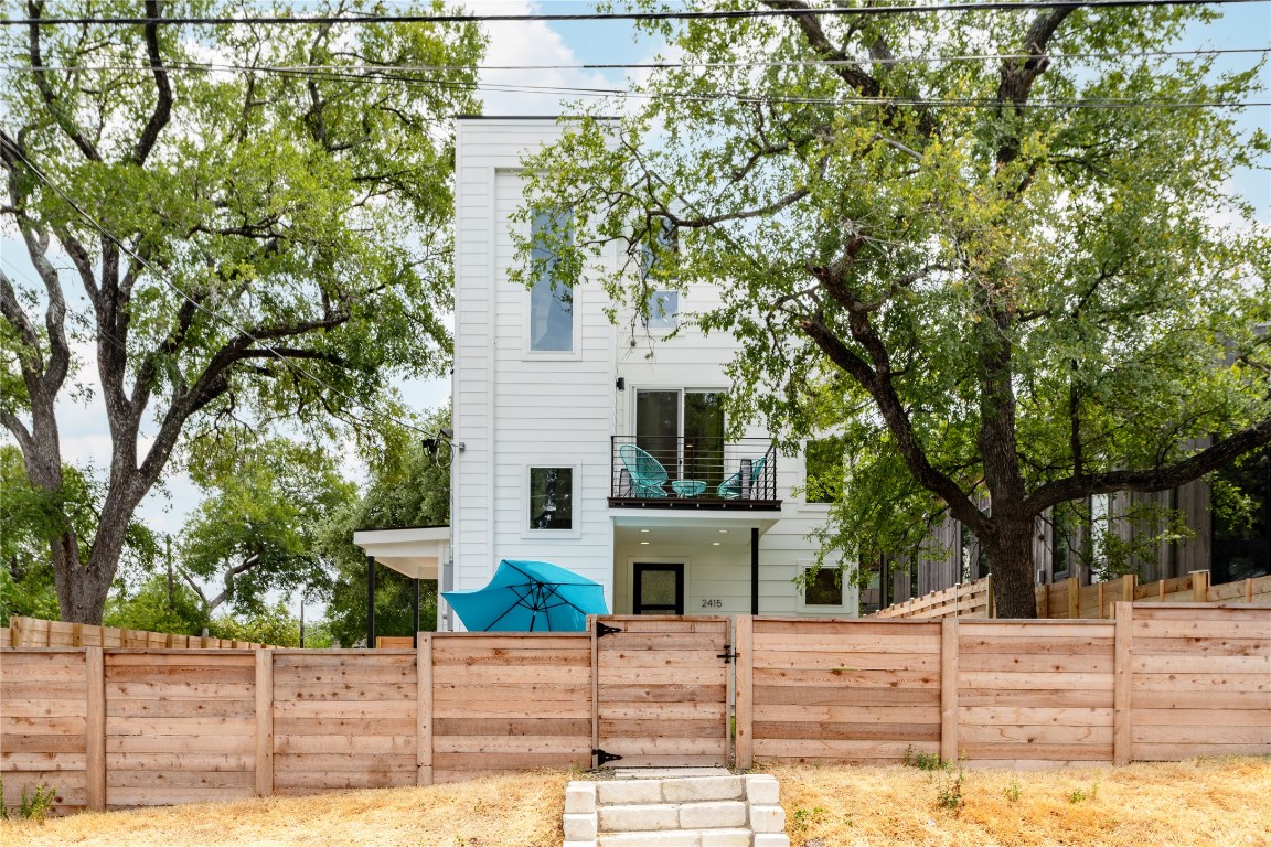 2415 East 10th Street Austin, TX 78702 - Photo 1 of 1 a view of a white house with large windows and a tree