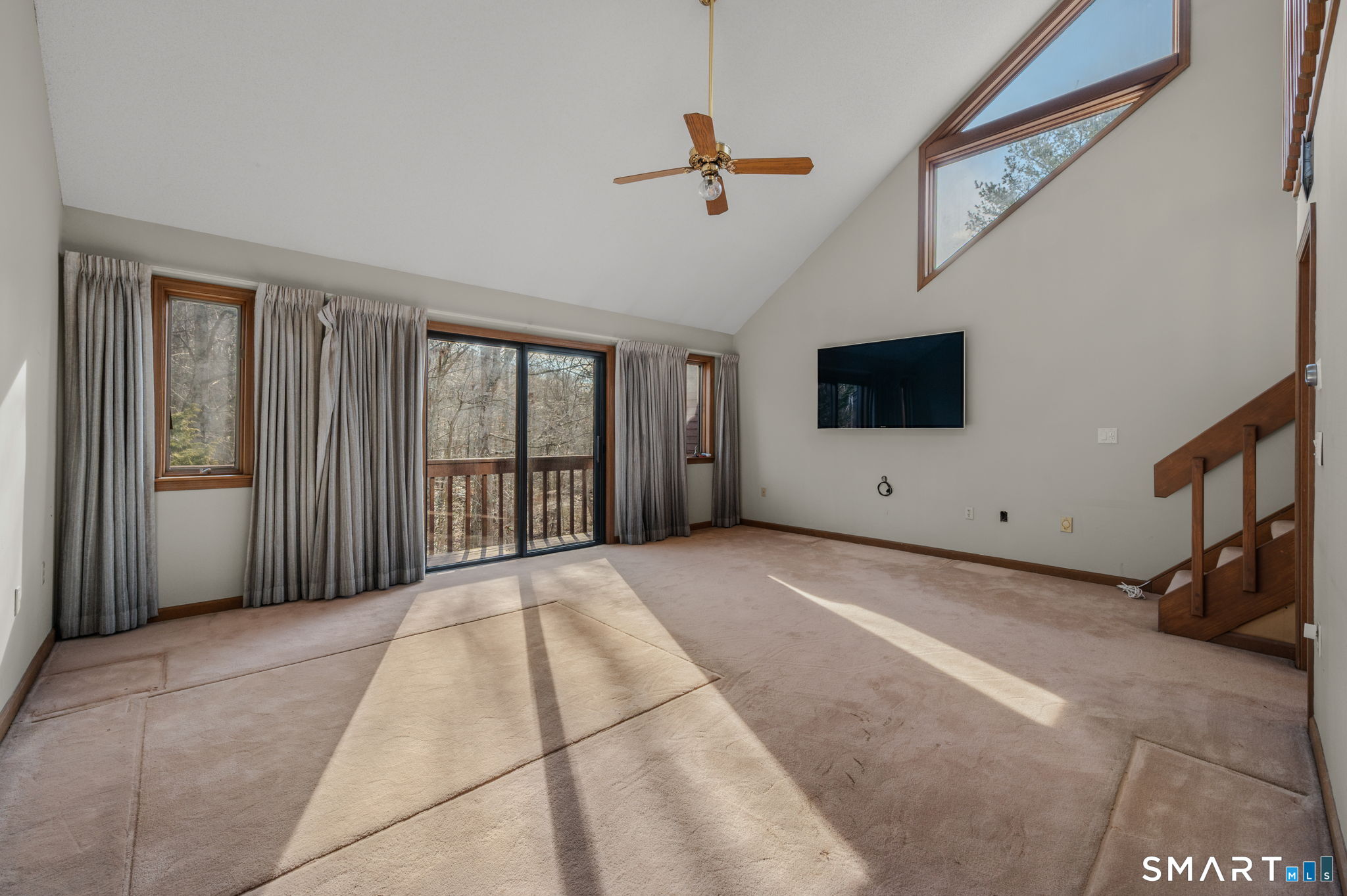 97 West Main Street, Unit 24 East Lyme, CT 06357 - Photo 23 of 39 a big room with windows and a flat screen tv