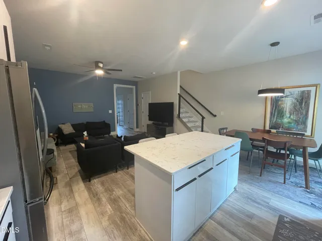 a view of a livingroom with furniture and an empty room