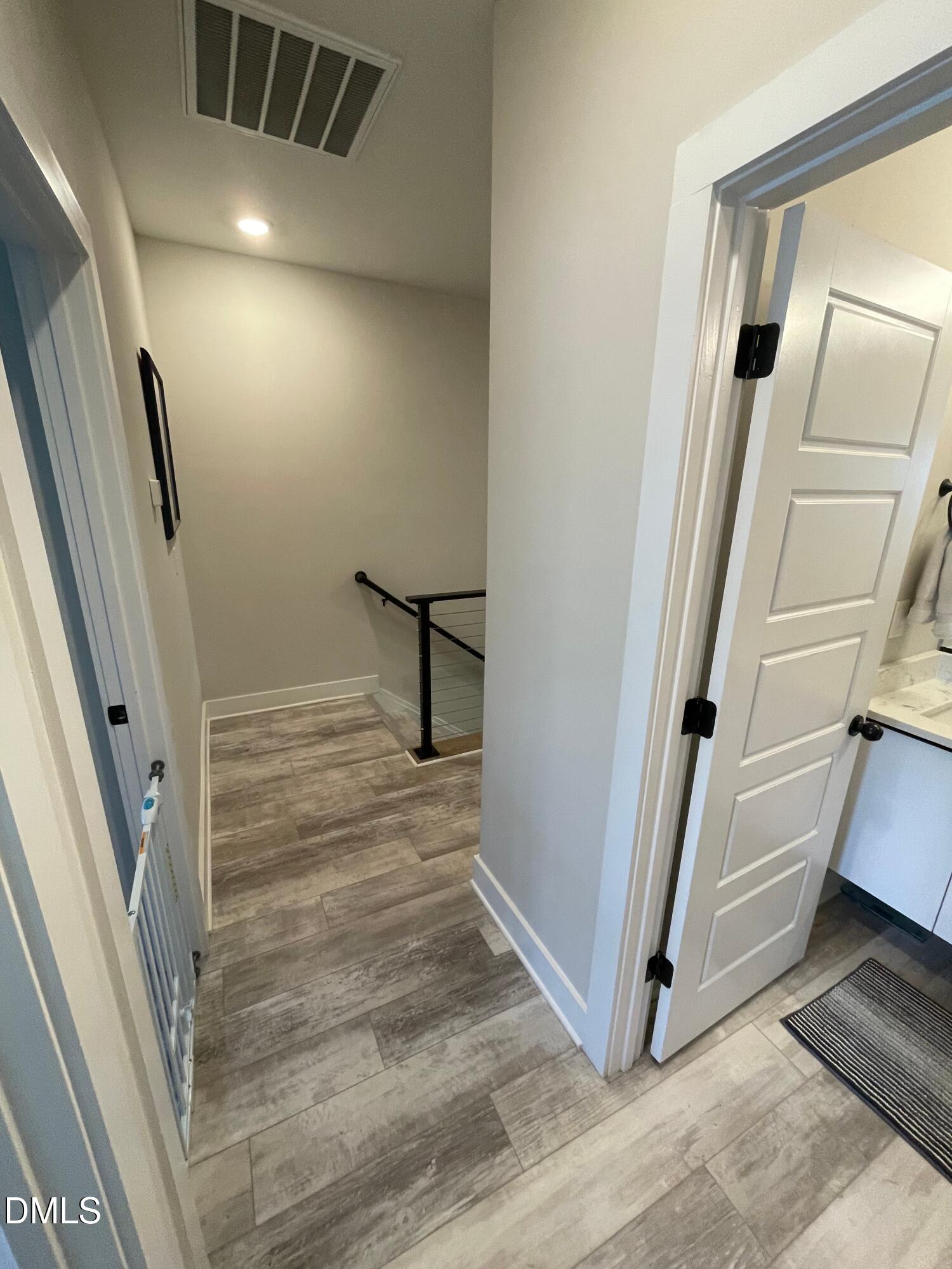 4108 Convergence Street Durham, NC 27704 - Photo 14 of 31 a view of a hallway with wooden floor and staircase