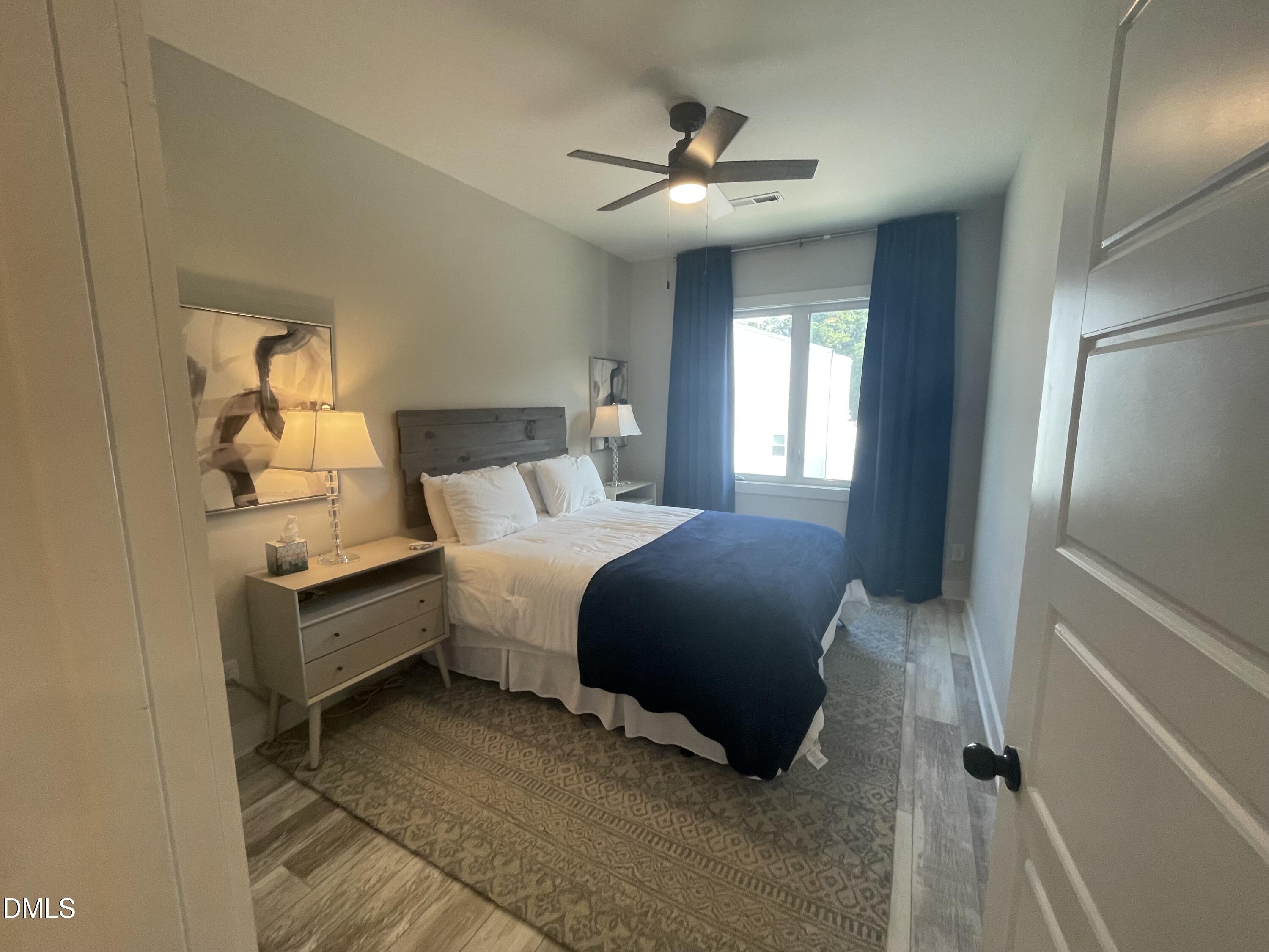 4108 Convergence Street Durham, NC 27704 - Photo 15 of 31 a bedroom with a bed and a chandelier