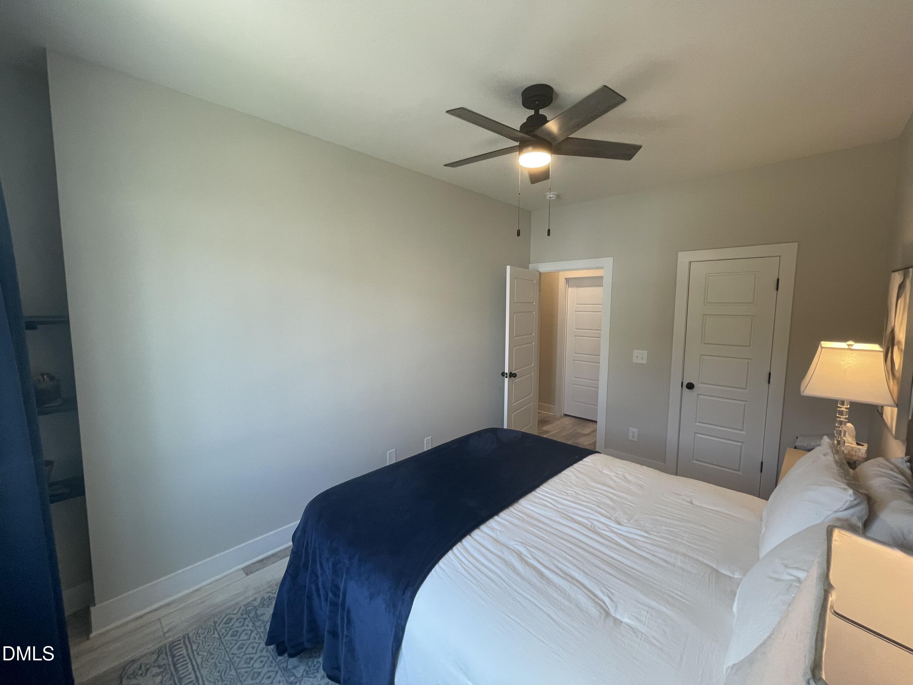 4108 Convergence Street Durham, NC 27704 - Photo 16 of 31 a bedroom with a bed and a lamp on the dresser