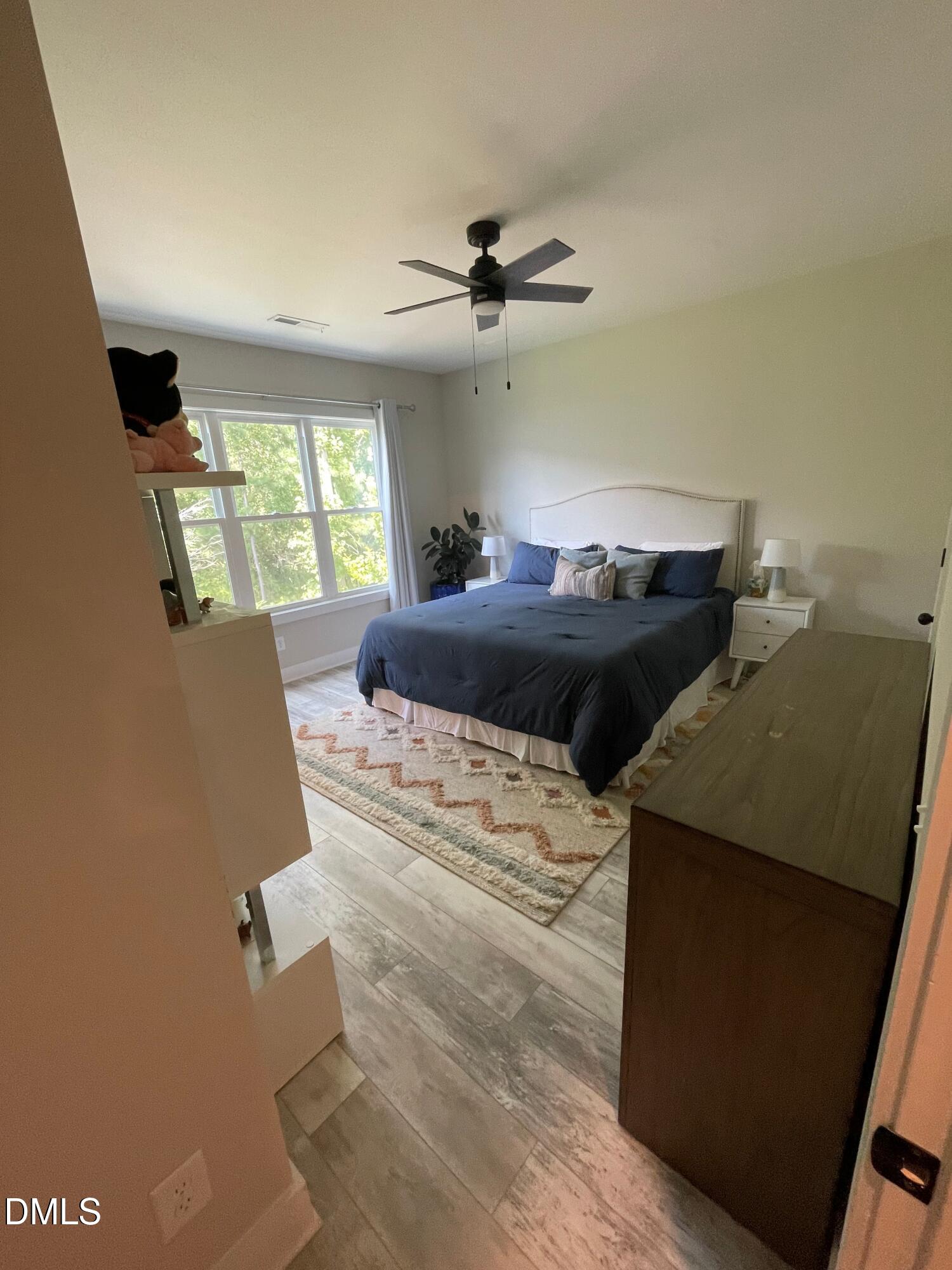 4108 Convergence Street Durham, NC 27704 - Photo 19 of 31 a bed sitting in a bedroom next to a window