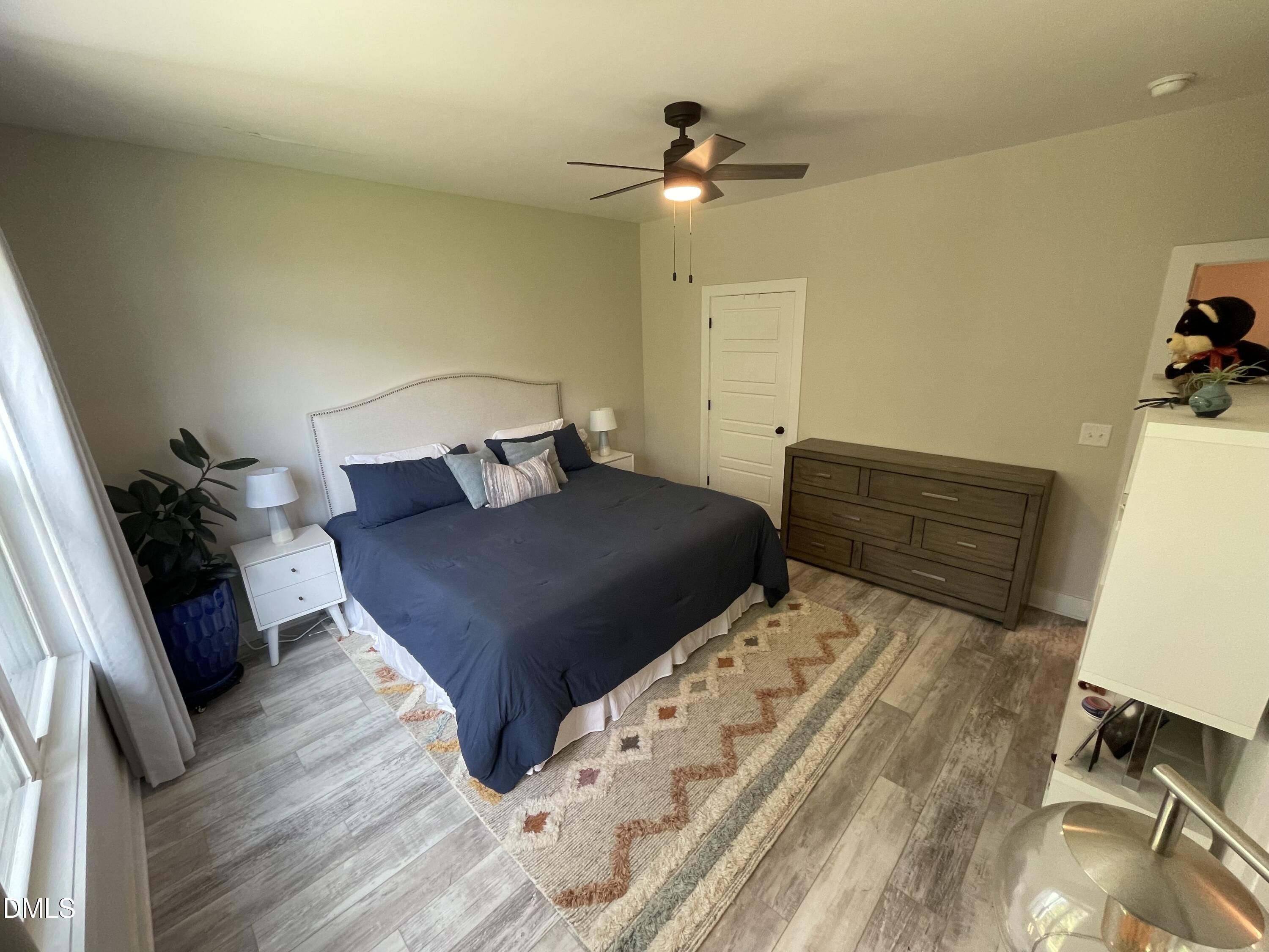 4108 Convergence Street Durham, NC 27704 - Photo 21 of 31 a bedroom with a bed and a dresser