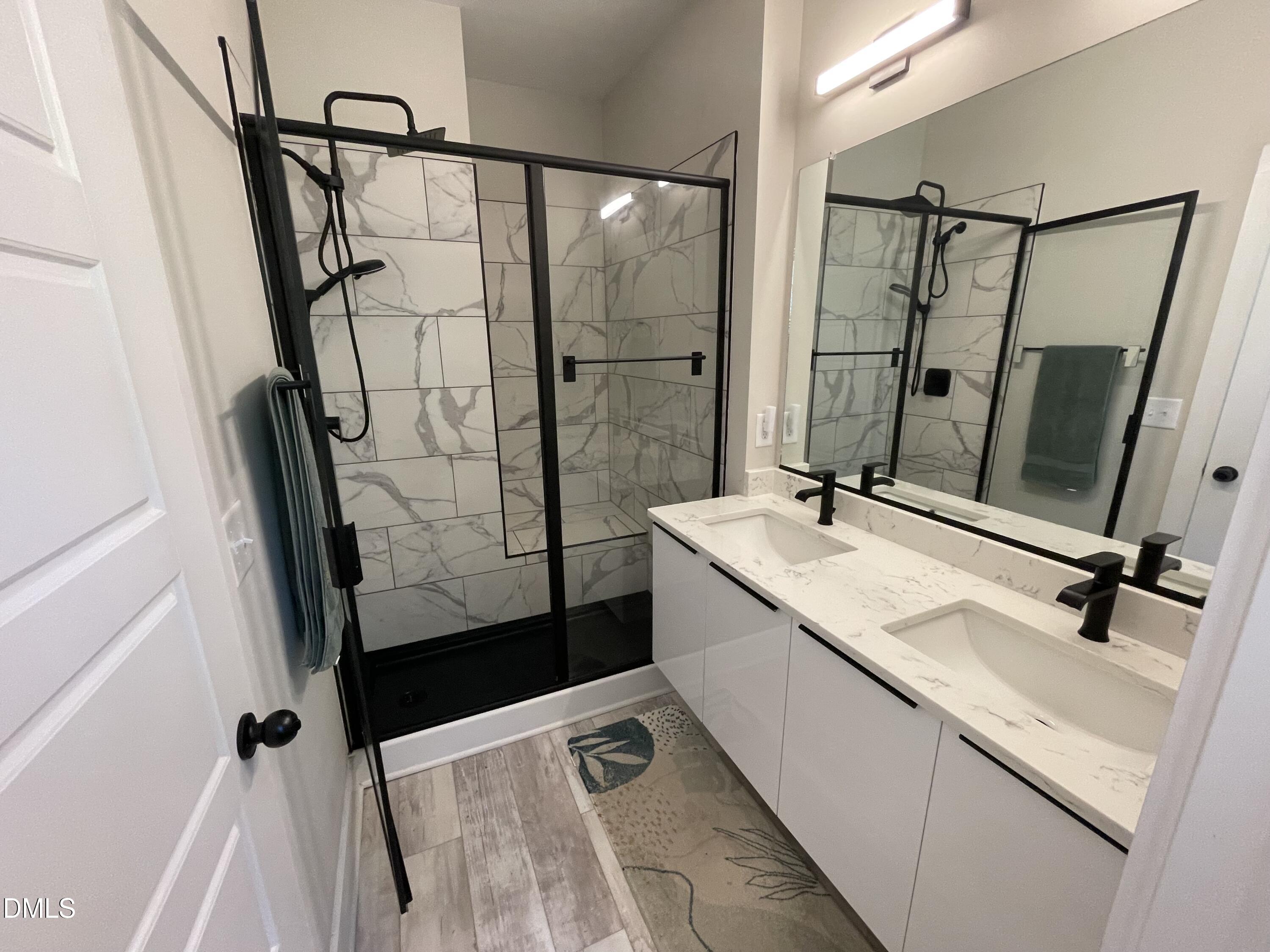 4108 Convergence Street Durham, NC 27704 - Photo 22 of 31 a bathroom with a double vanity sink mirror and shower