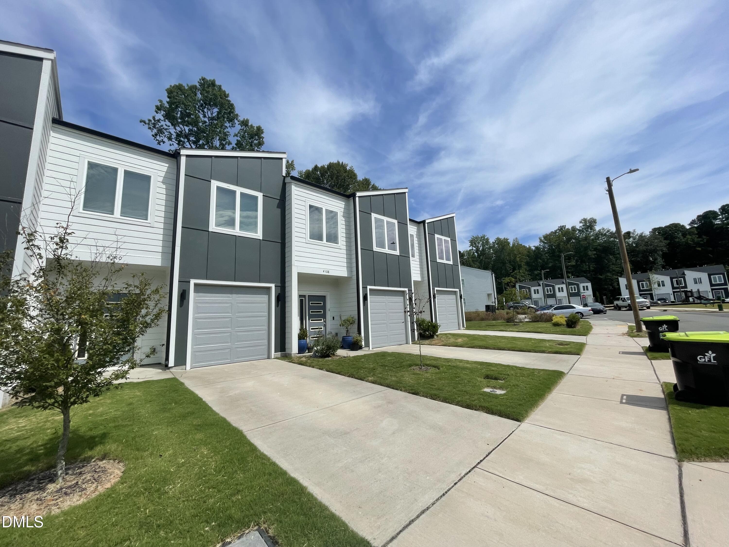 4108 Convergence Street Durham, NC 27704 - Photo 2 of 31 a front view of a house with swimming pool having outdoor seating